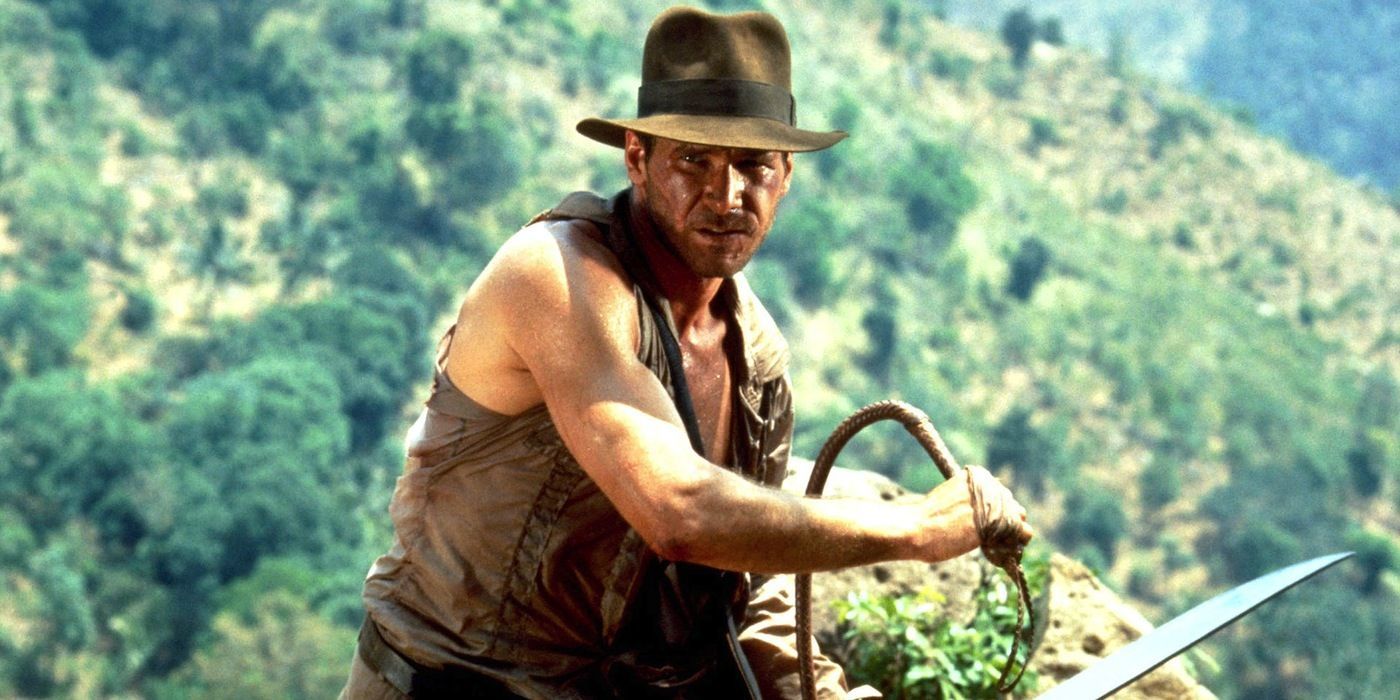 Indiana Jones on a bridge holding a whip and sword in and the Temple of Doom (1984)