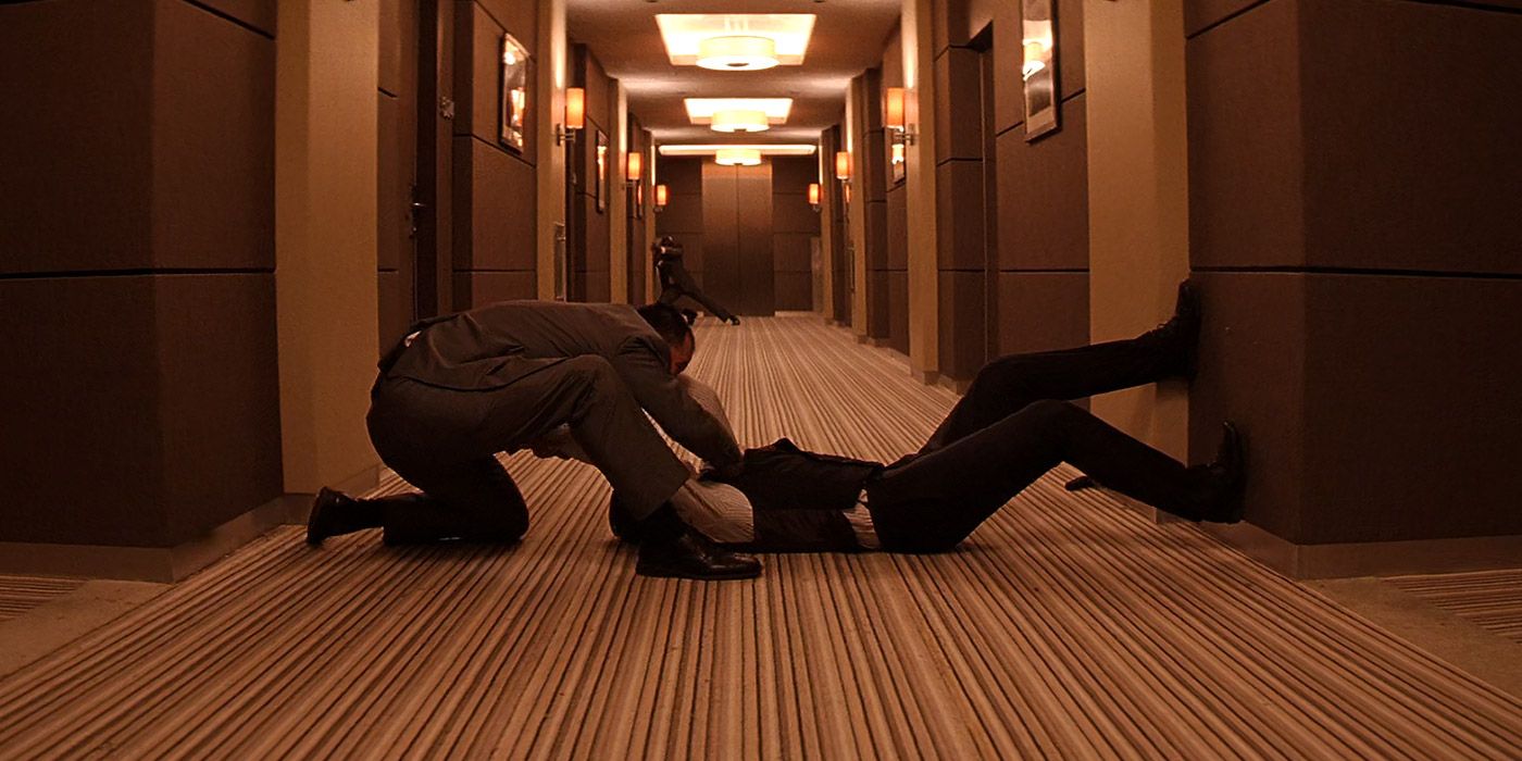 Arthur fights two men in a hallway in Inception