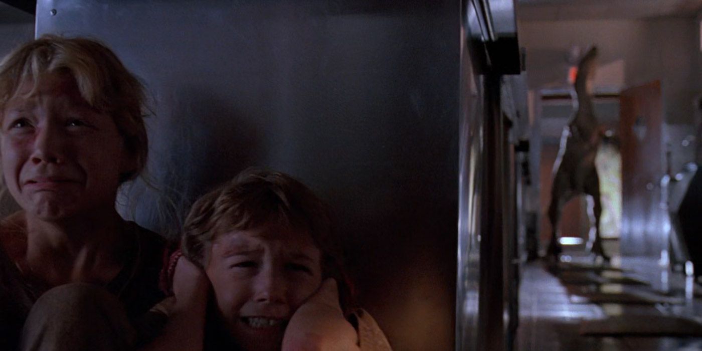 Lex and Tim hide from velociraptors in a kitchen in Jurassic Park