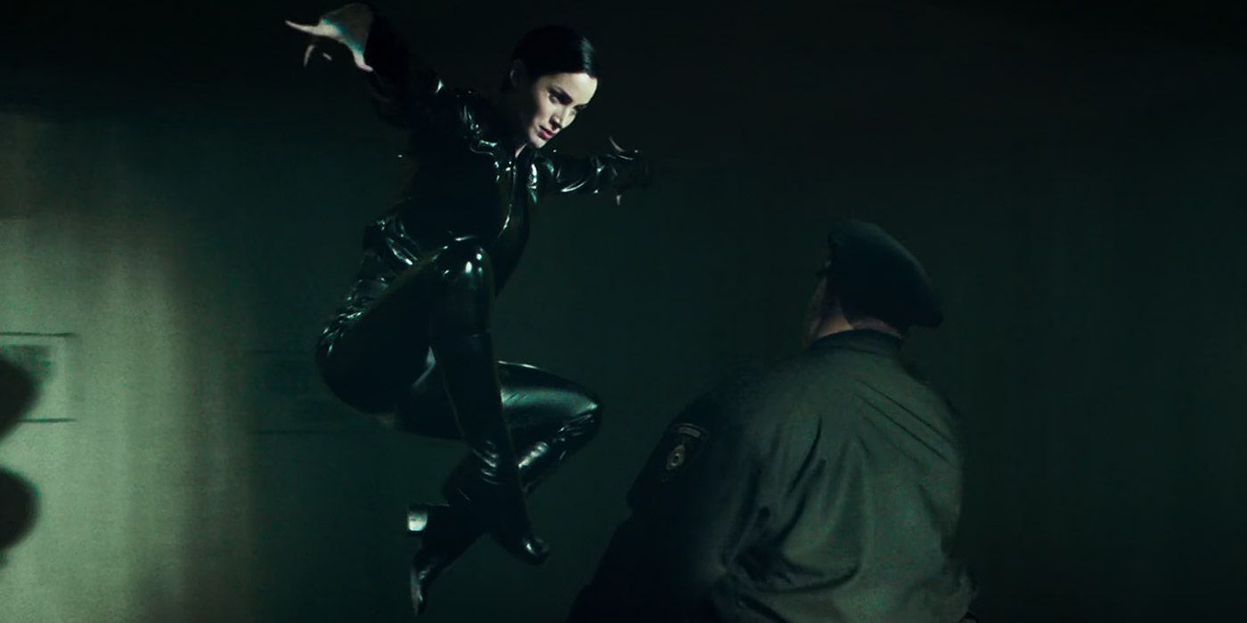 Trinity does a jump kick on a police officer in The Matrix