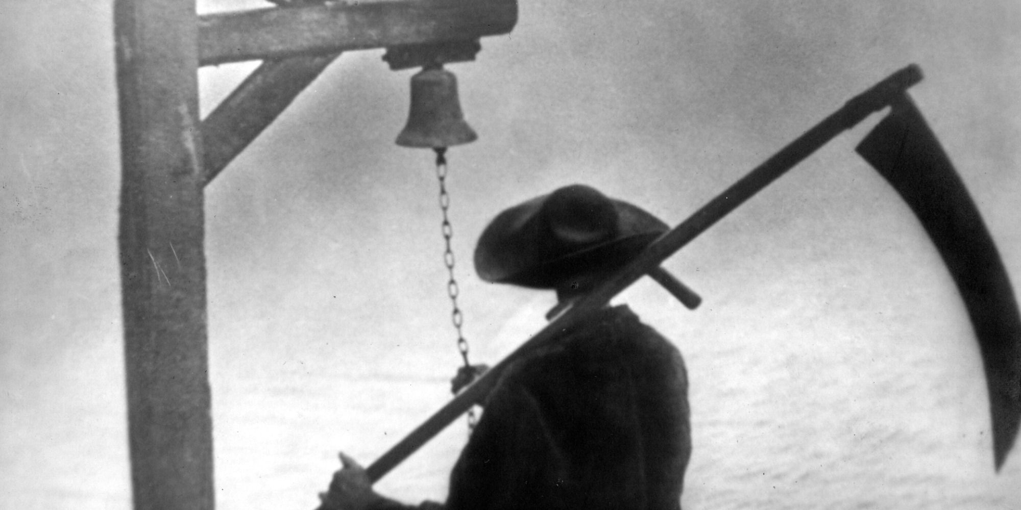 A man near a bell holding a scythe in Vampyr (1932)