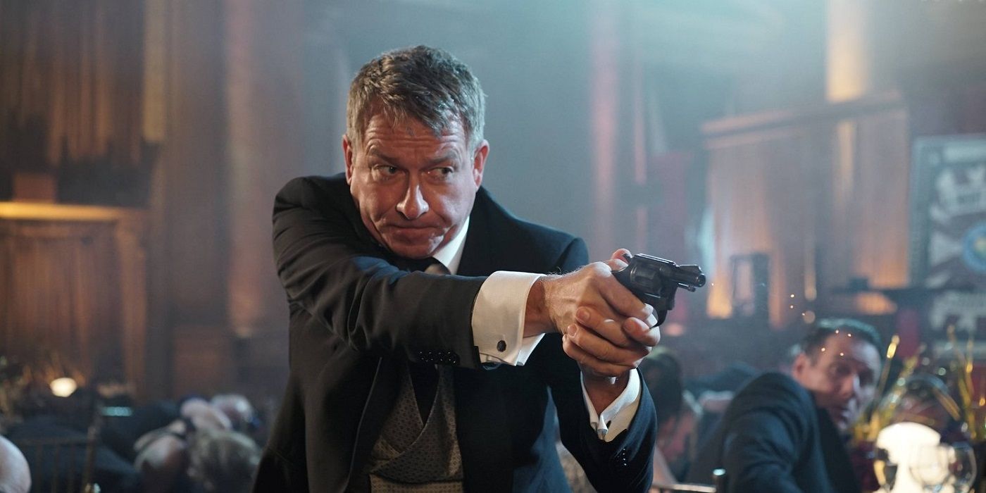 Alfred shooting a gun in Gotham