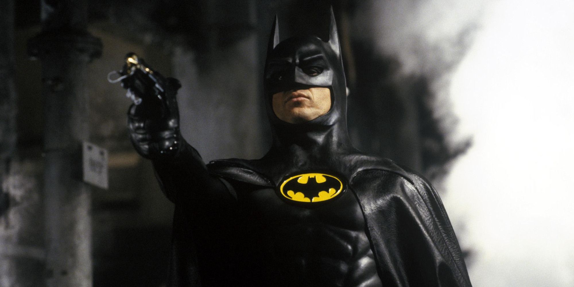 Batman aims his grappling gun in Batman 1989