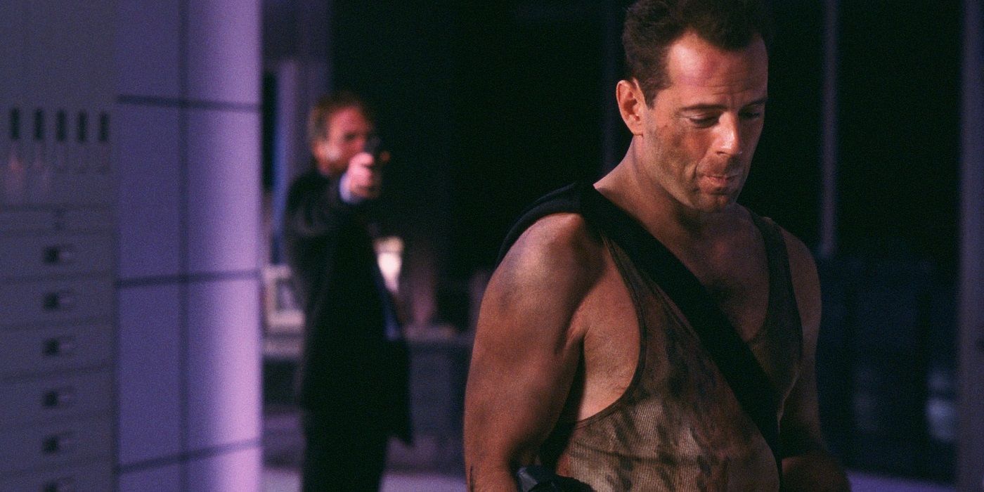 Hans Gruber aiming a gun at John McClane in Die Hard