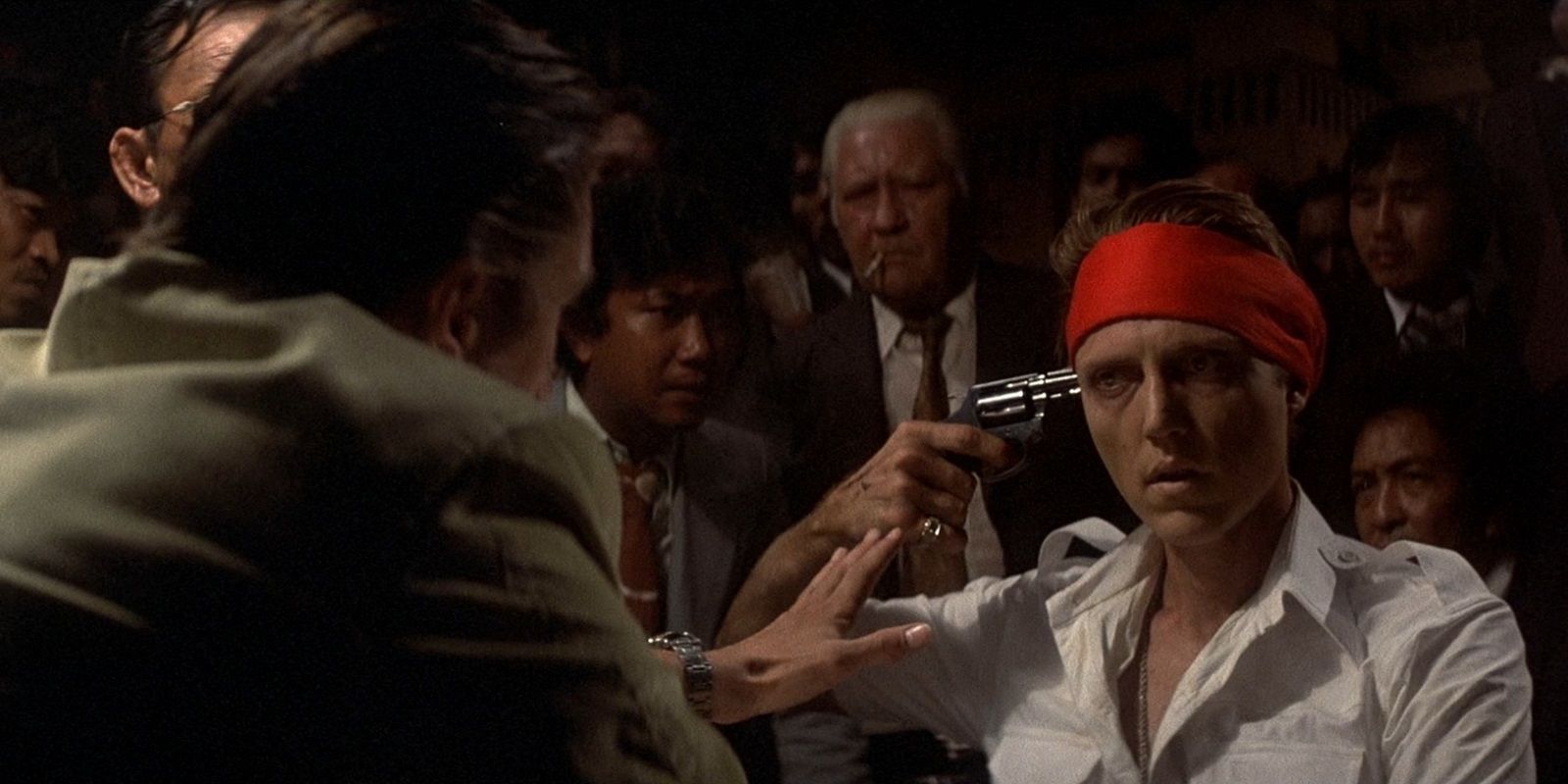 Christopher Walken pointing a gun to his head in the Deer Hunter Russian Roulette scene
