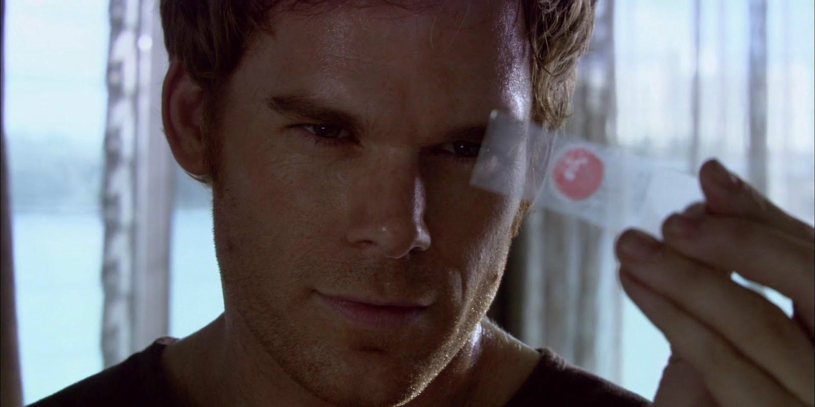 Dexter looking at a card during the Pilot