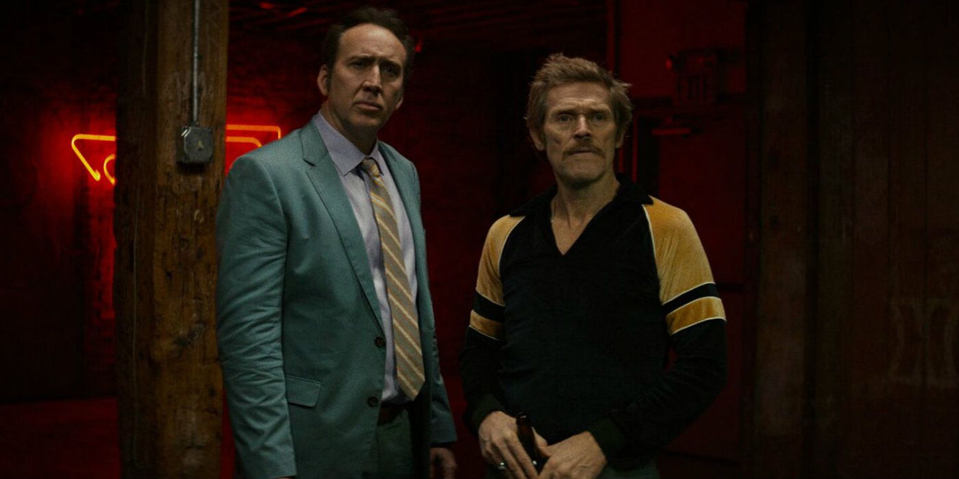 Nicolas Cage and Willem Dafoe looking off-camera in Dog Eat Dog
