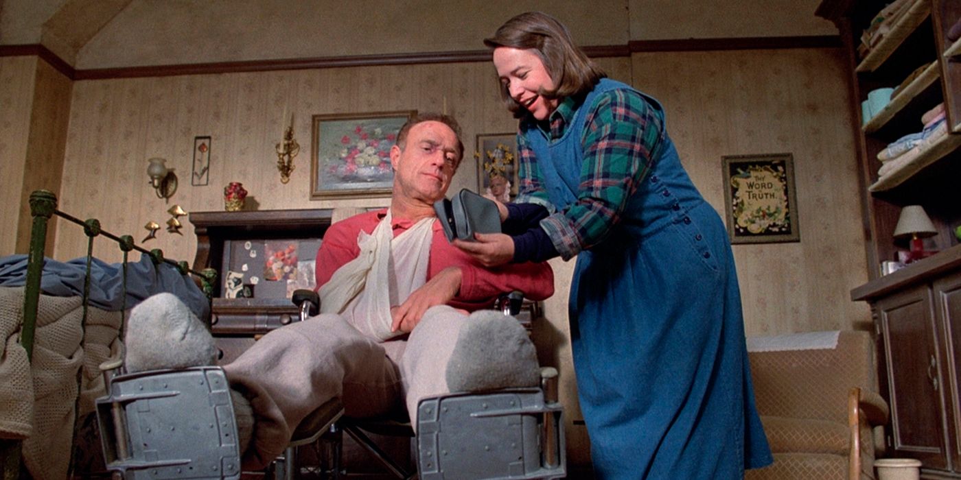 A scene from Misery showing Paul in a wheelchair and Annie standing over him