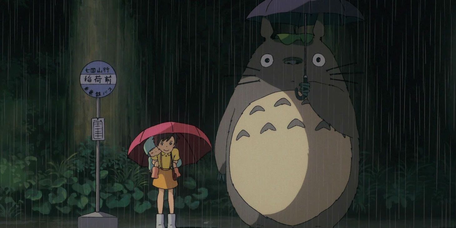 Mei and Satsuki standing in the rain next to Totoro