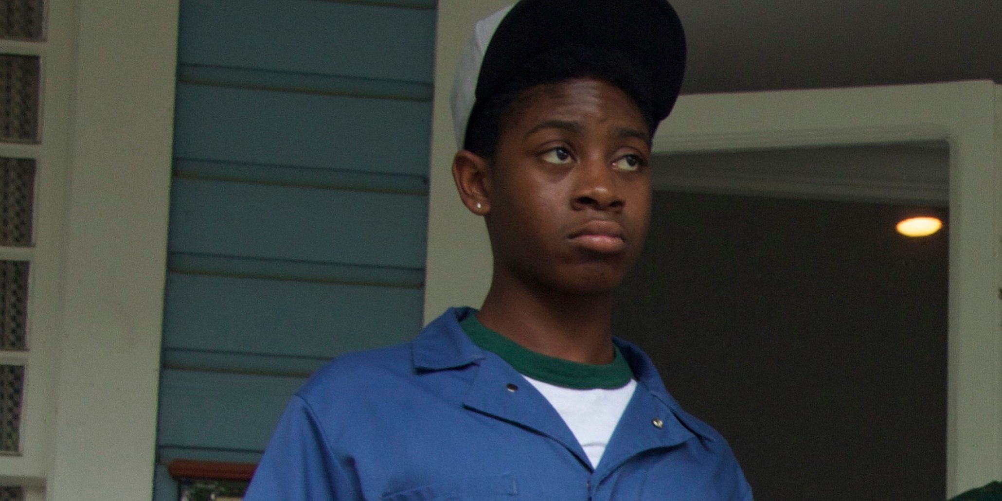 RJ Cyler stands and stares forward in Me and Earl and the Dying Girl