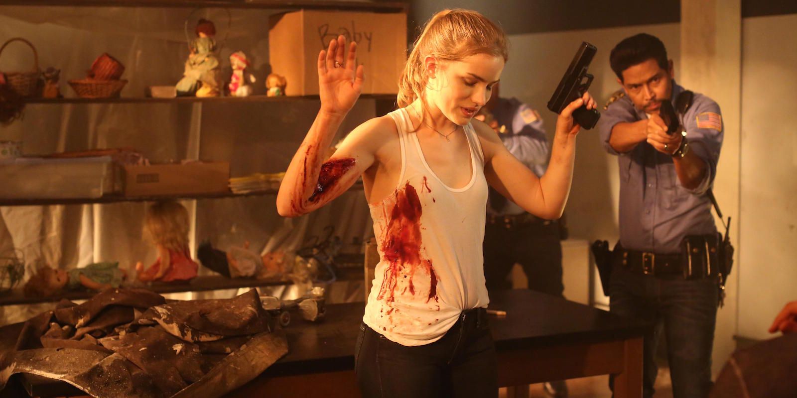 Emma with her hands up and bleeding as cops arrive in Scream