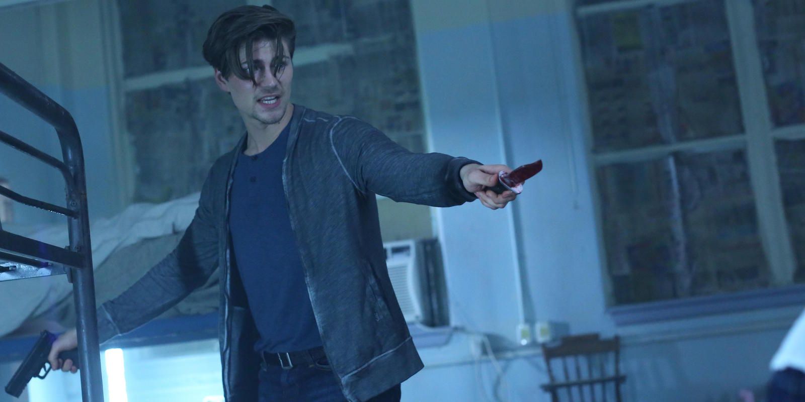 Kierani holds a gun and wields a bloody knife in the TV show Scream.