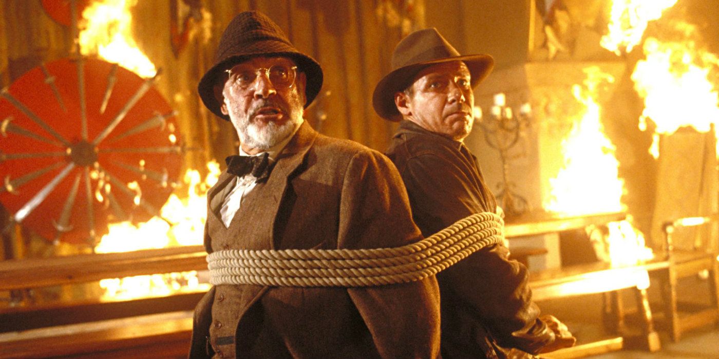 Indiana Jones and Henry Jones Sr. tied to a chair together in in Indiana Jones and the Last Crusade.