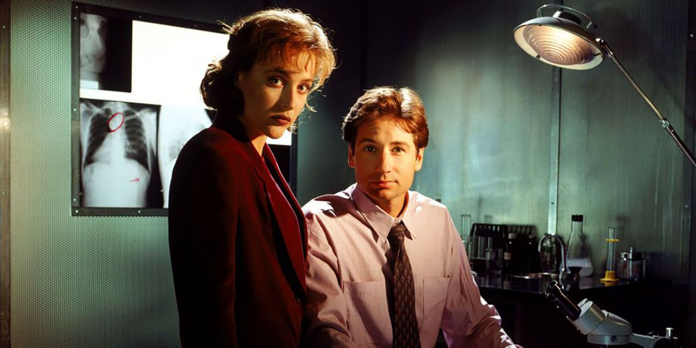 Scully and Mulder in a hospital room looking at the camera in The X-Files.