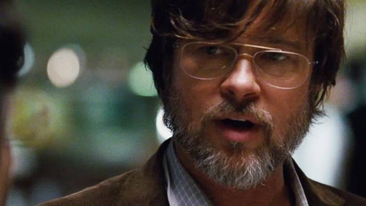 A bearded Ben Rickert (Brad Pitt) having a serious conversation with a person who's offscreen in The Big Short