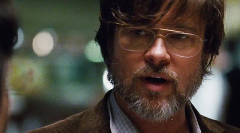 A bearded Ben Rickert (Brad Pitt) having a serious conversation with a person who's offscreen in The Big Short