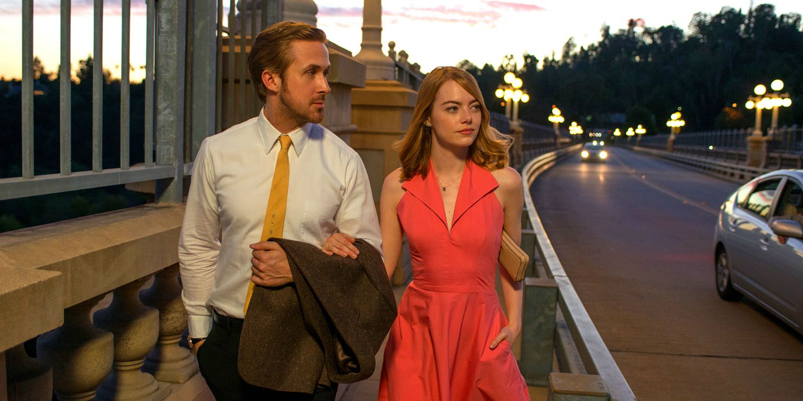 Ryan Gosling and Emma Stone walking down the sidewalk in La La Land