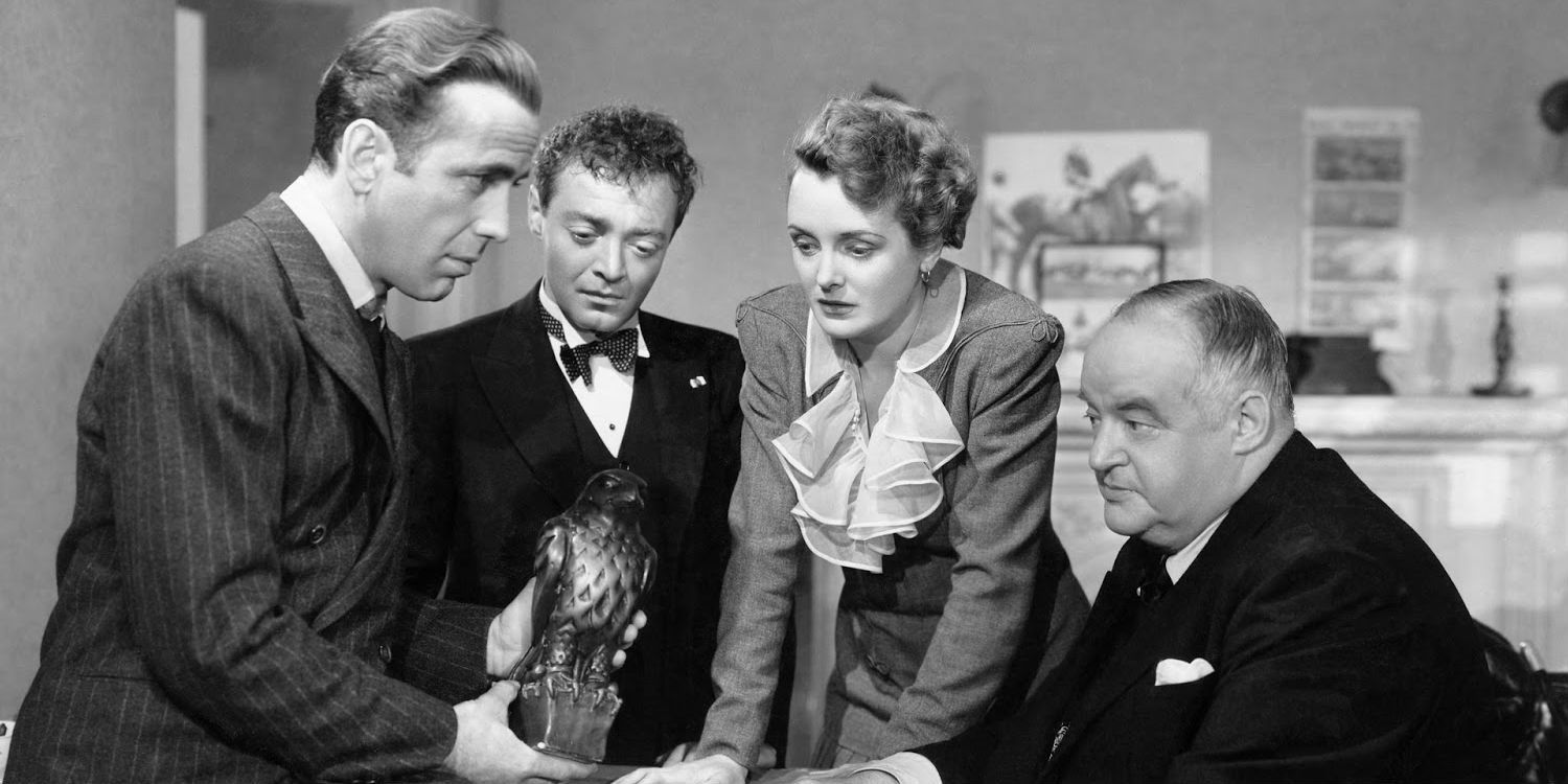 A group of people standing around a maltese falcon