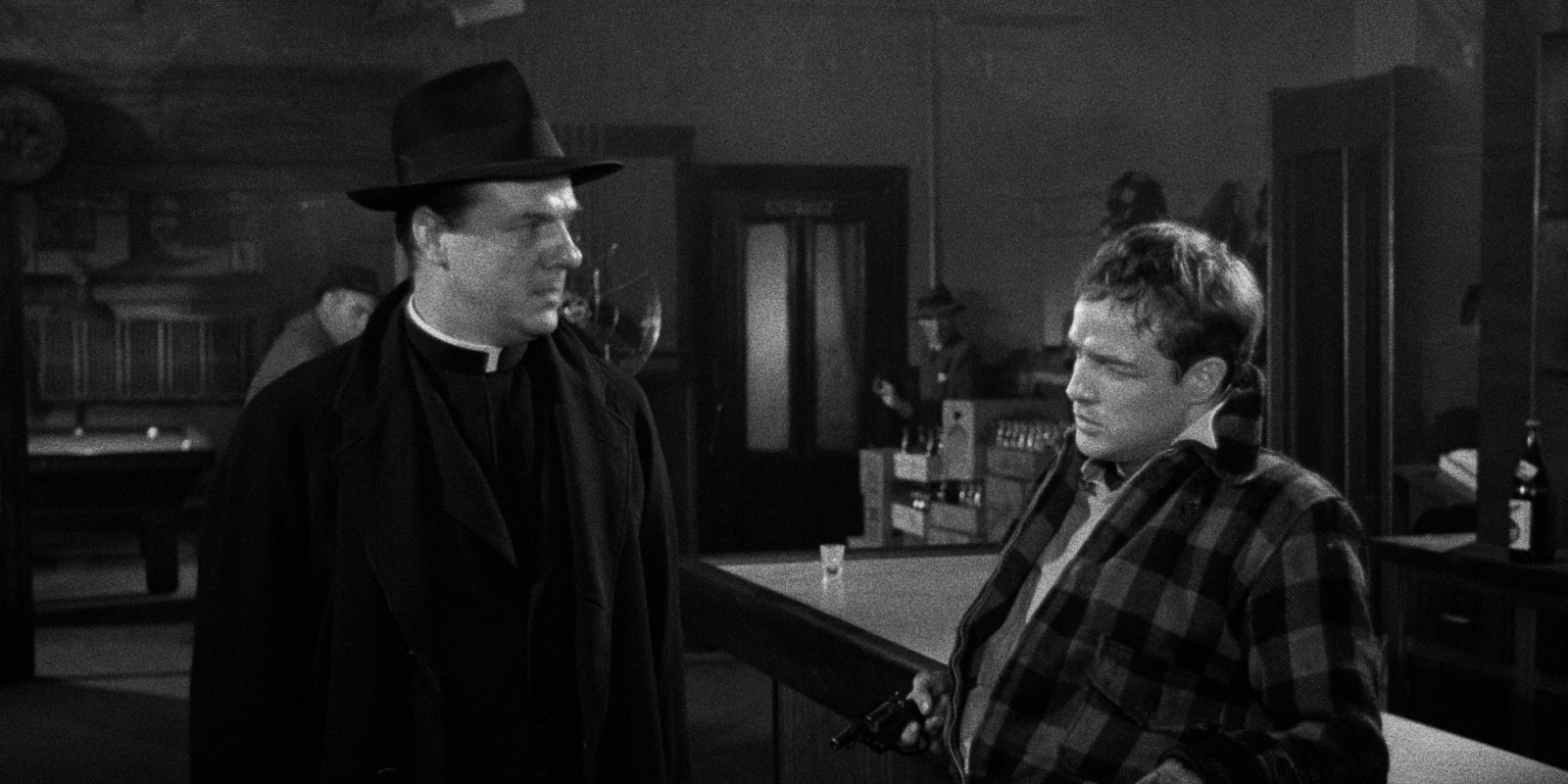 Marlon Brando in On The Waterfront leans against a bar.