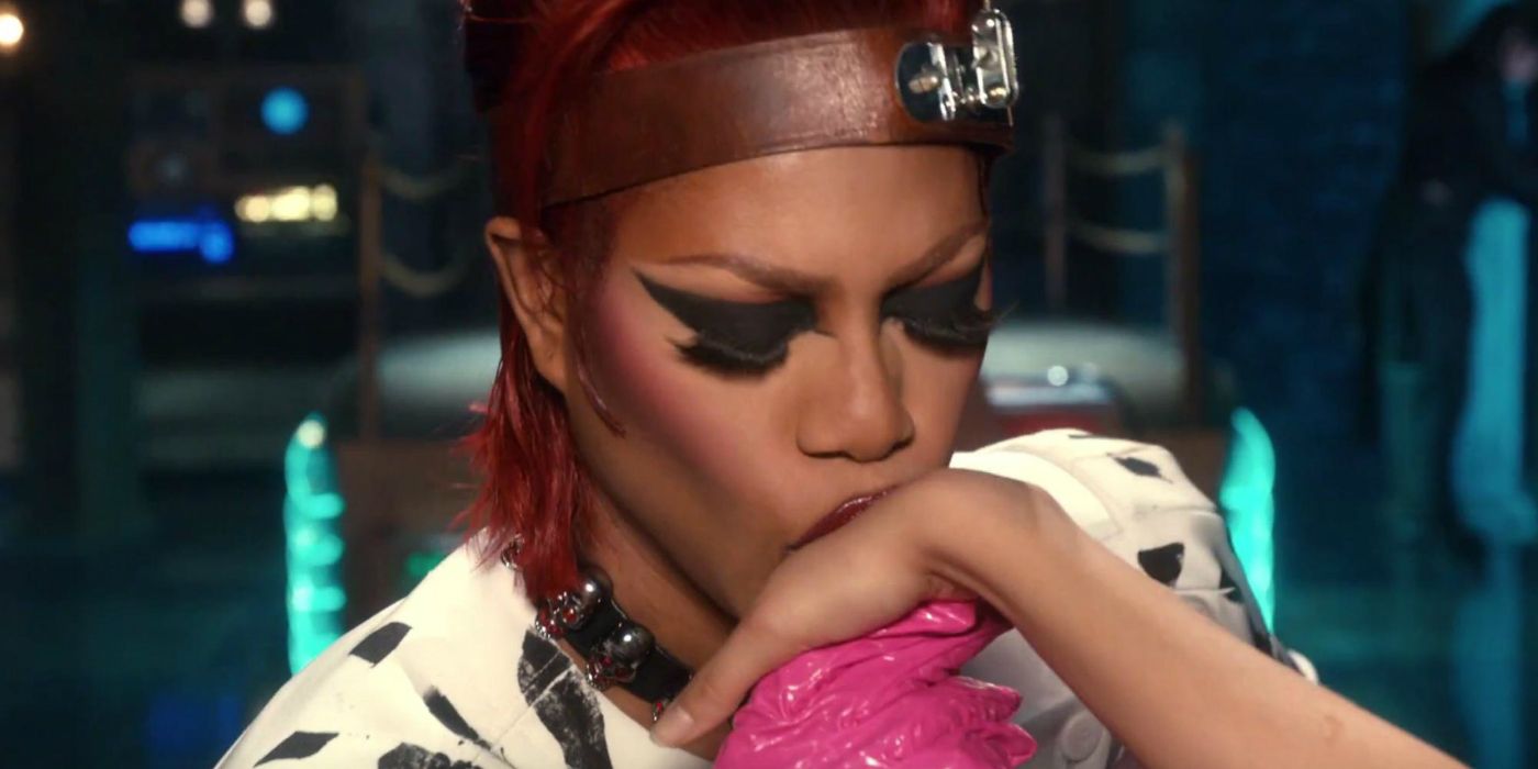  Laverne Cox as Dr. Frank-N-Furter with a leather headband kissing someone's hand with closed eyes in Rocky Horror Picture Show Let's Do the Time Warp Again