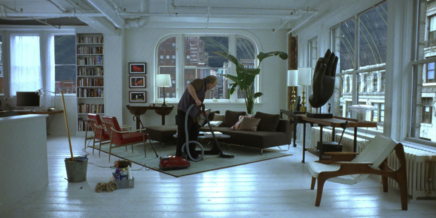 Caden cleans an empty, modern apartment in Synecdoche, New York
