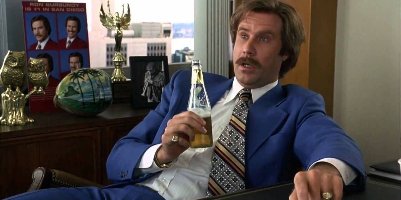 Ron drinks a beer at his desk in Anchorman