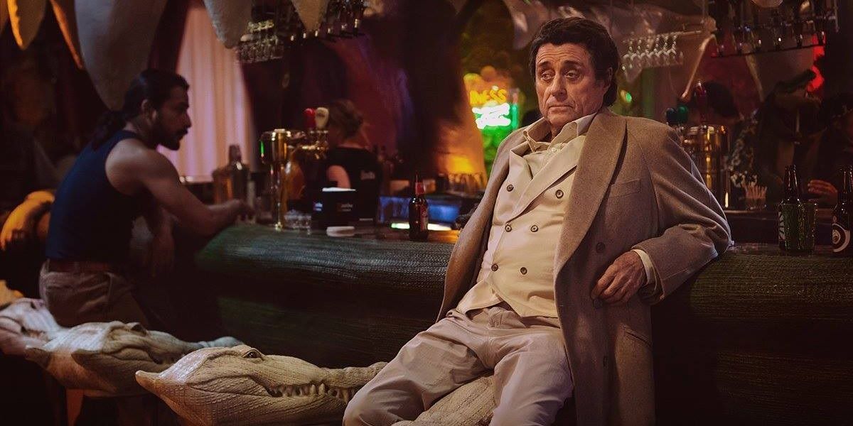 Ian McShane as Mr Wednesday in American Gods sitting at the bar