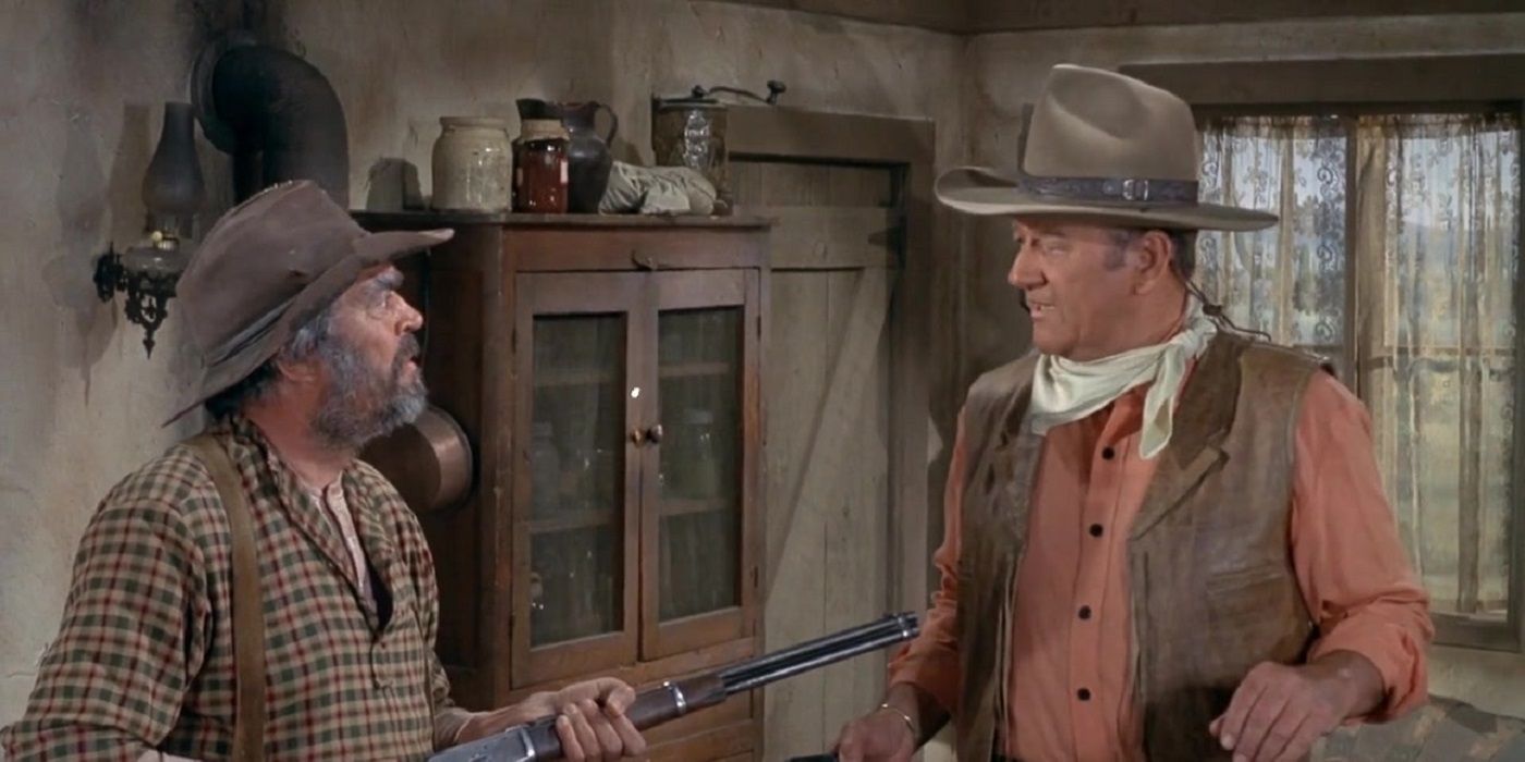 John Wayne held at gunpoint by Jack Elam in Rio Lobo