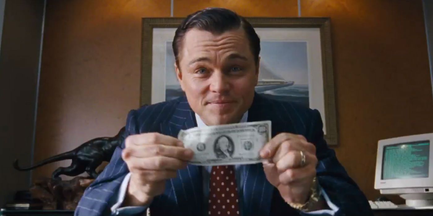 Jordan Belfort showing a dollar to the camera in The Wolf of Wall Street.