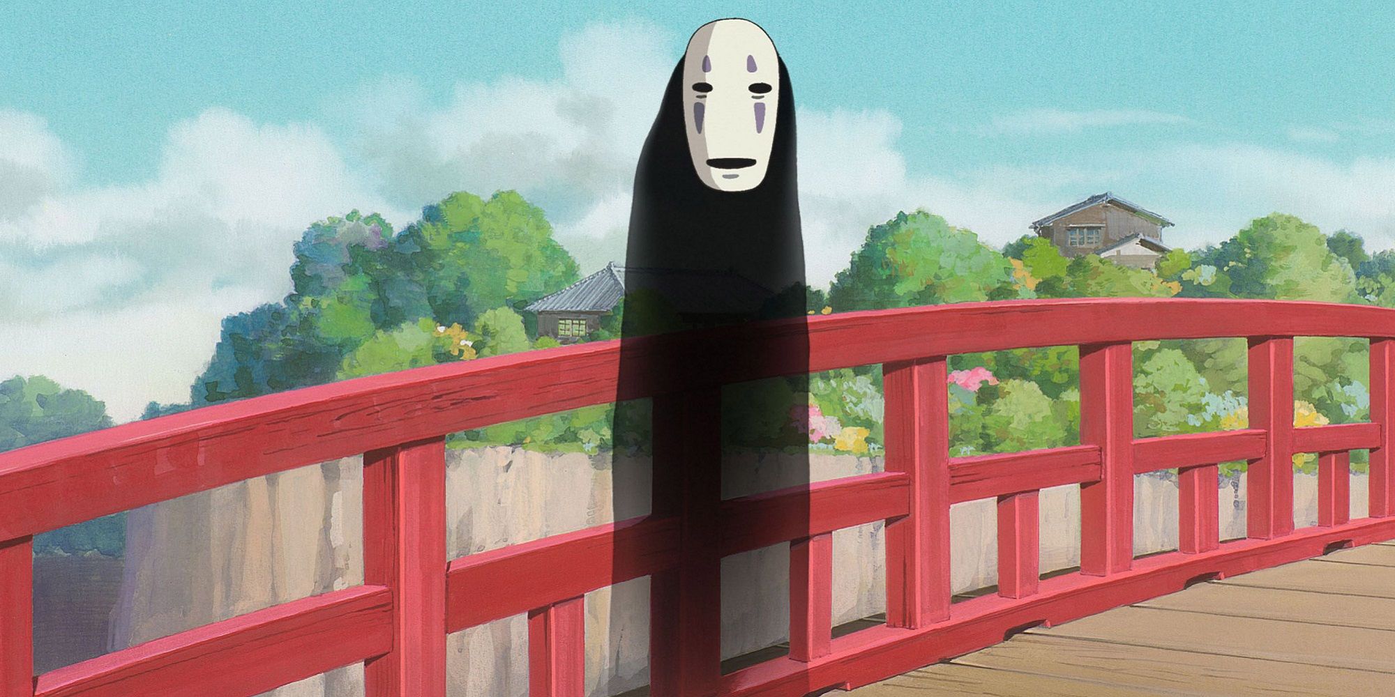 No Face stands on a red bridge during the day in Spirited Away.