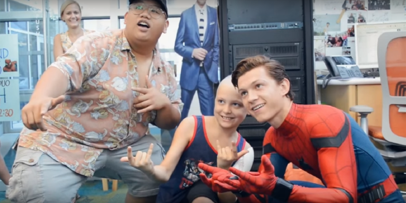 Tom Holland dressed as Spider-Man visiting children at a hospital