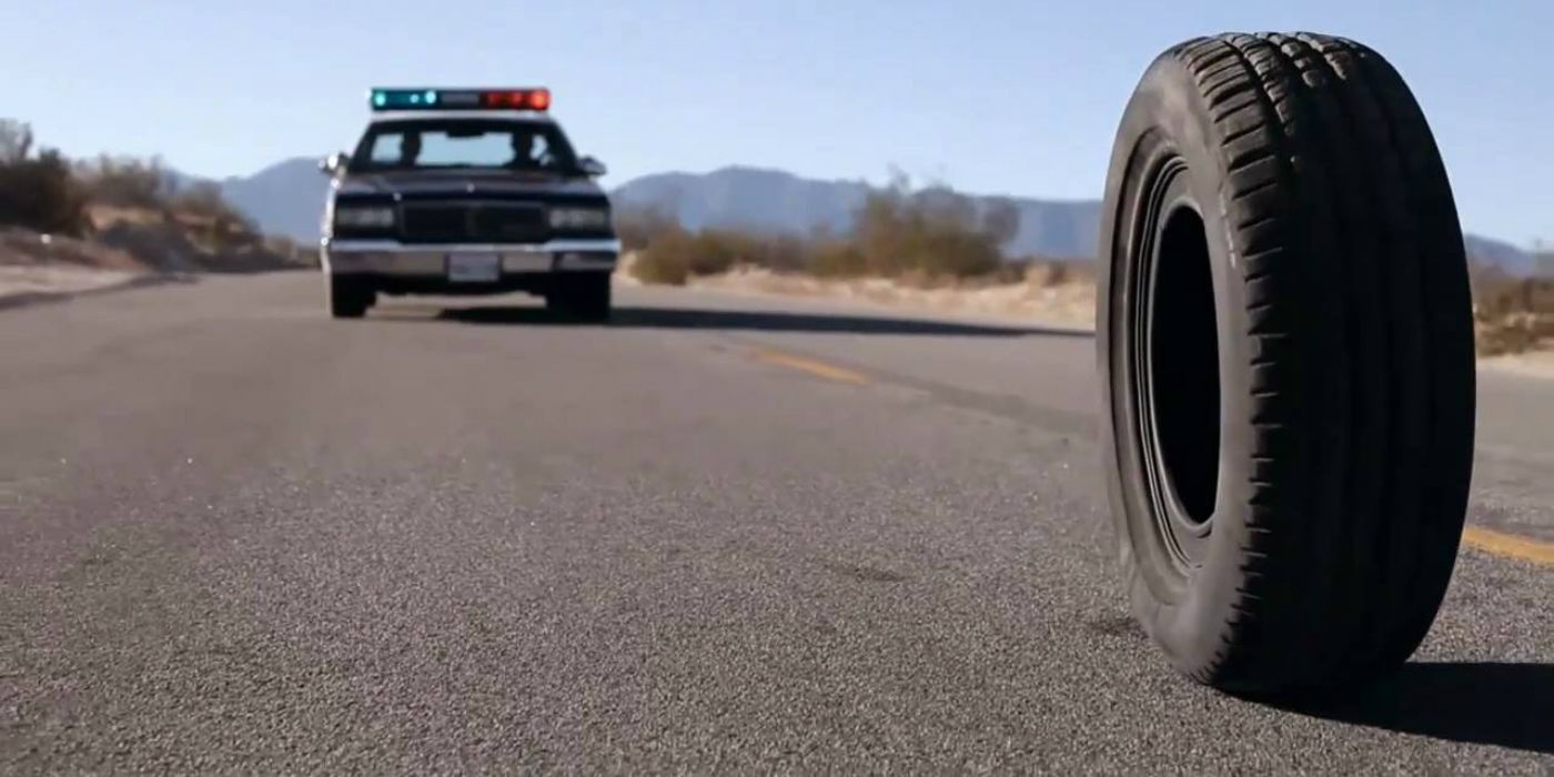 A still from Rubber showing evil tire being chased by a police car