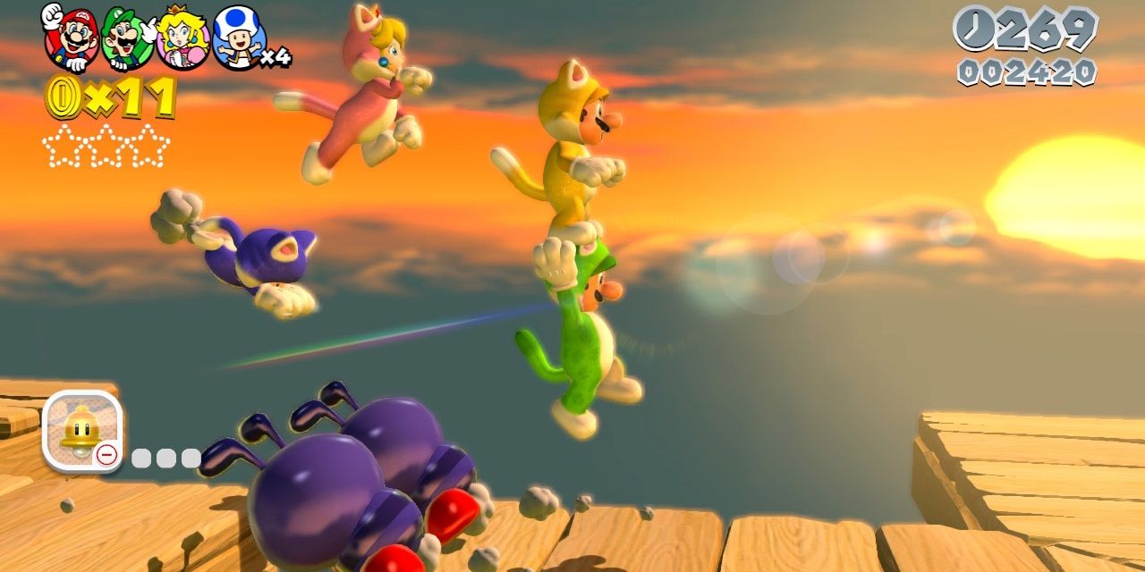 Super Mario 3D World screenshot showing 4 players in cat-suits working together to jump over enemies