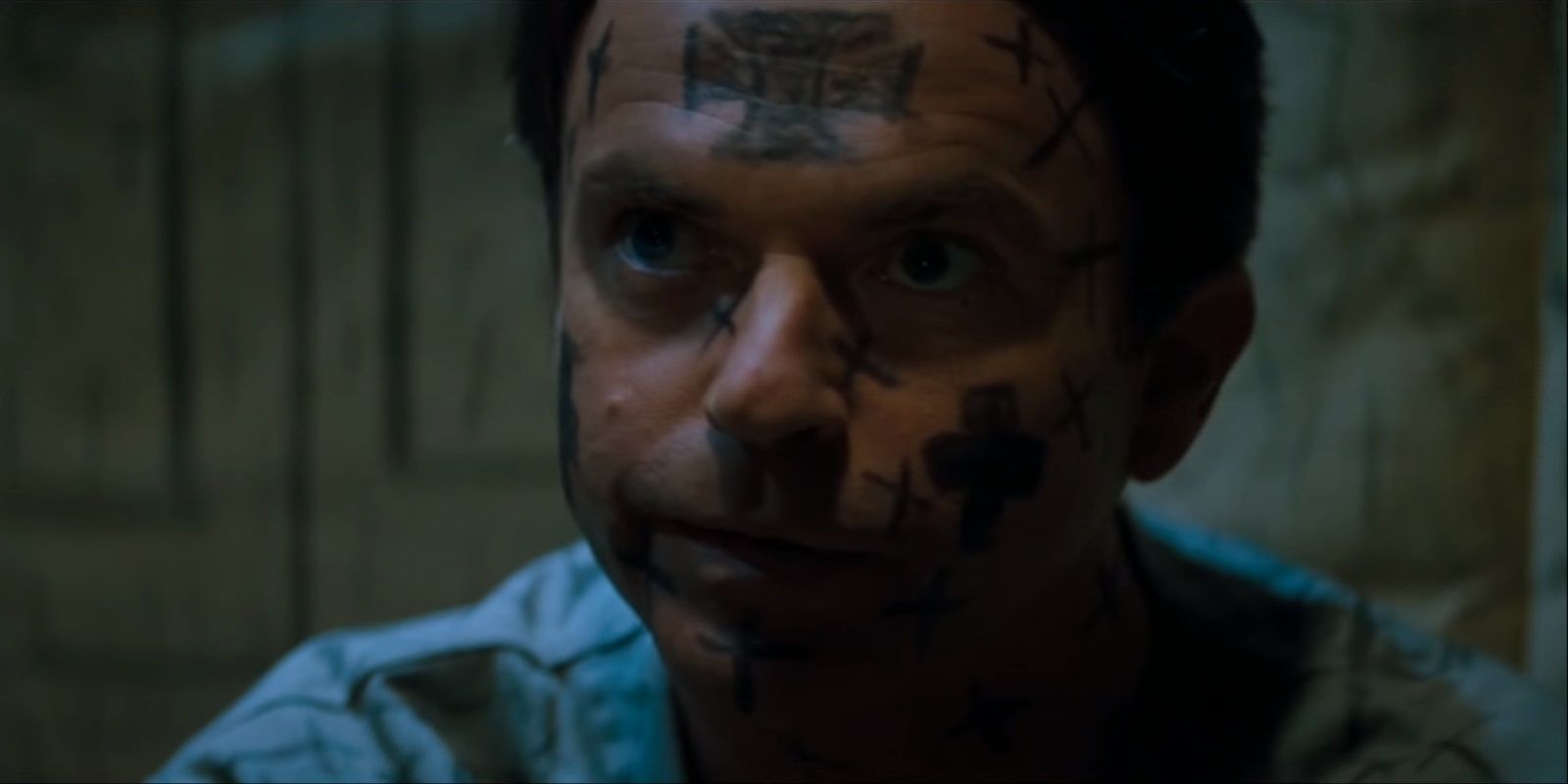 In The Mouth of Madness Sam Neill in an Asylum Covered in Crosses