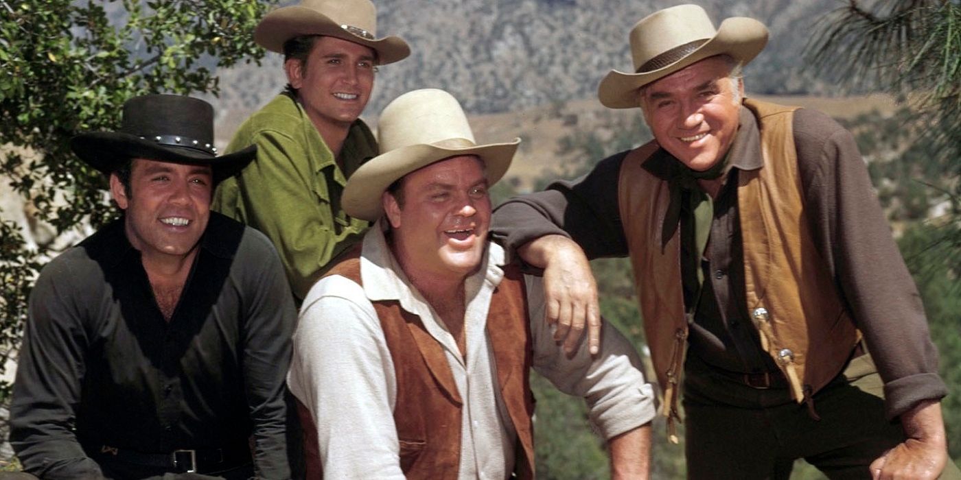 Pa, Hoss, Adam, and Little Joe Cartwright share a laugh in the countryside in the TV show Bonanza.
