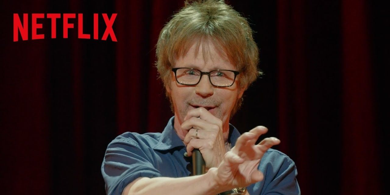 Dana Carvey speaking on a mic in a still from Straight Male Ego