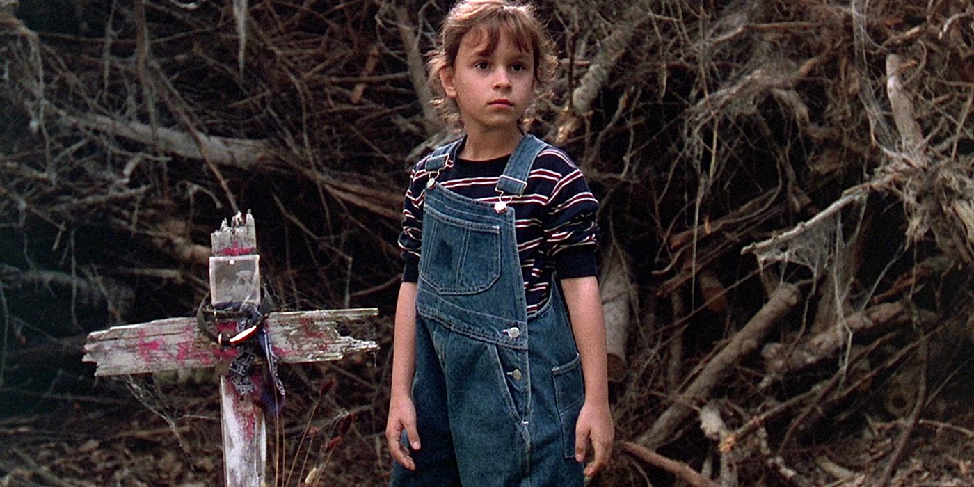 Ellie standing in front of a grave in Pet Sematary