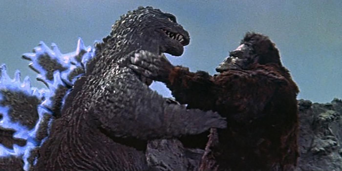 King Kong and Godzilla grapple in the countryside from King Kong vs Godzilla 