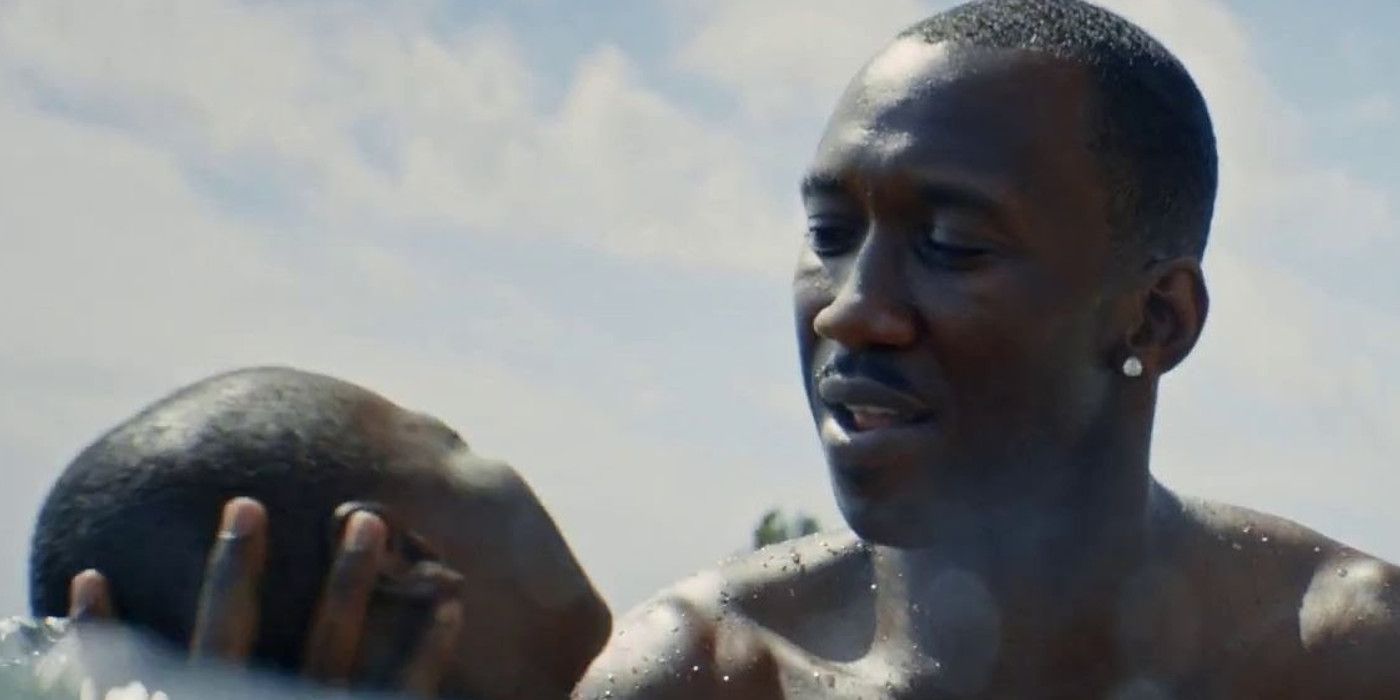 Mahershala Ali holds a boy in the water in Moonlight