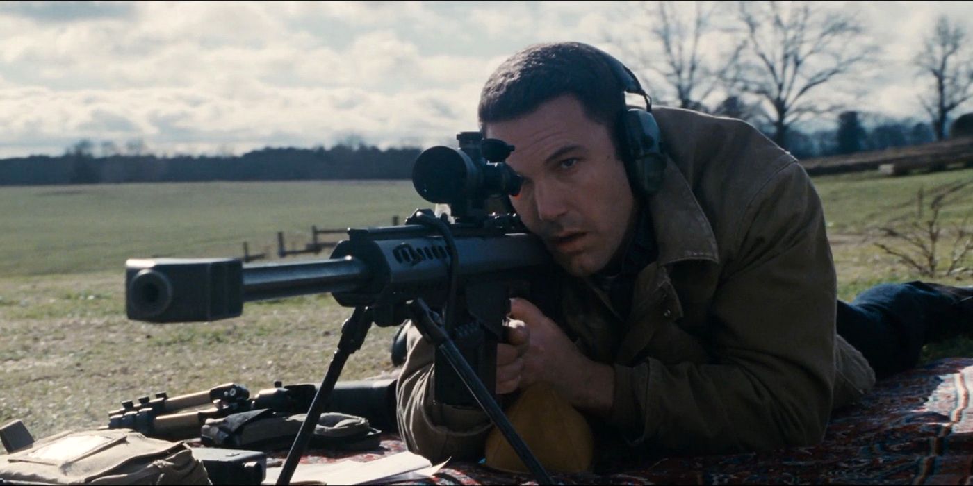 Ben Affleck aiming a sniper rifle in The Accountant