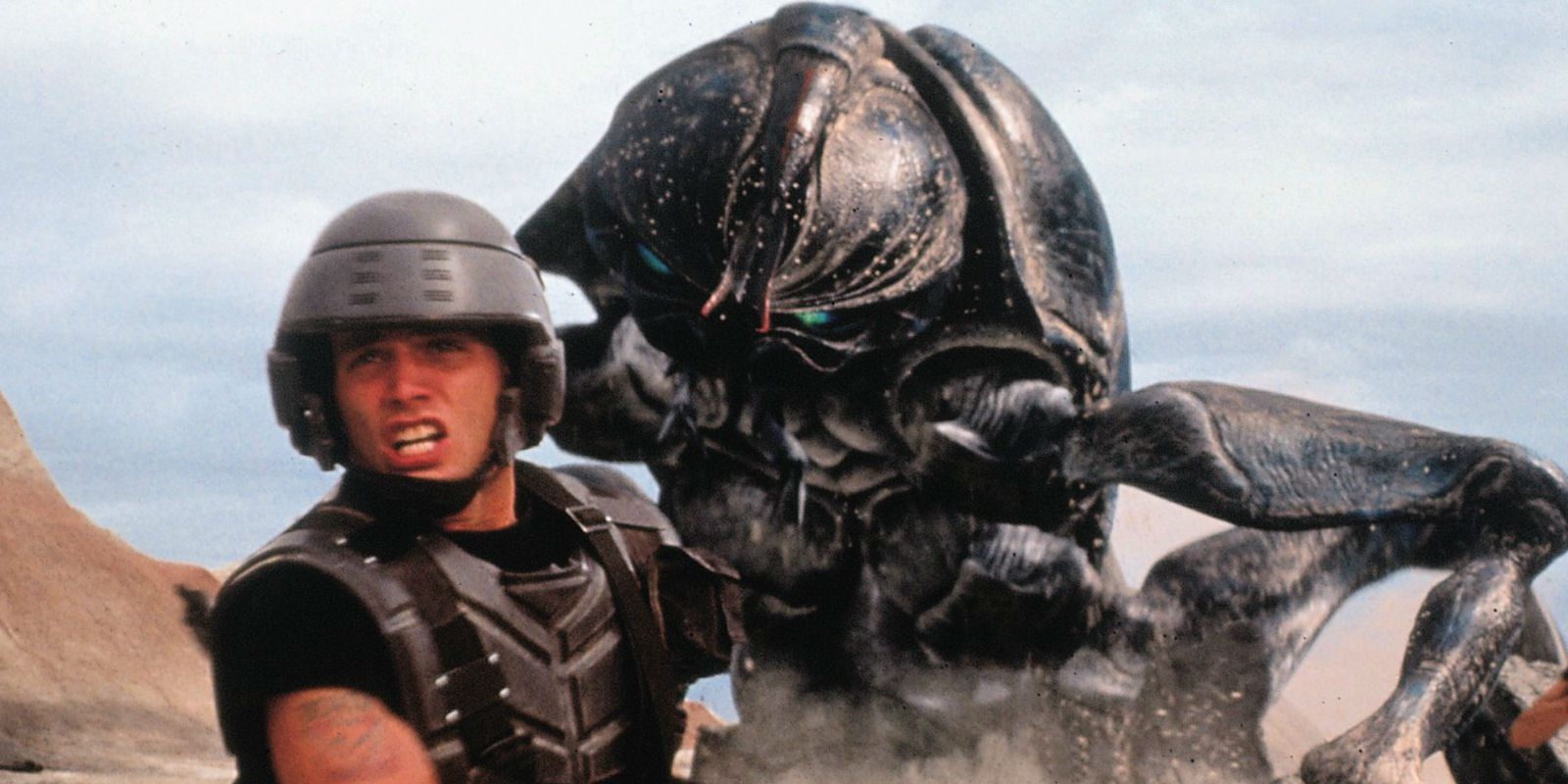 Rico running from a giant bug in Starship Troopers 