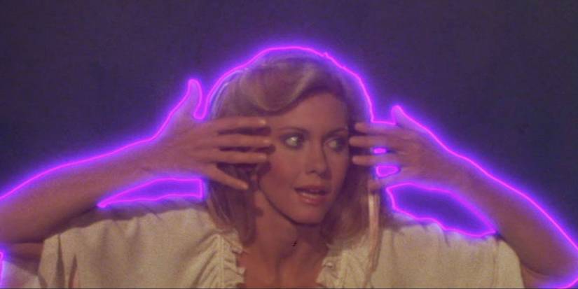 Olivia Newton-John as Kira with purple outline and hands to her face in Xanadu