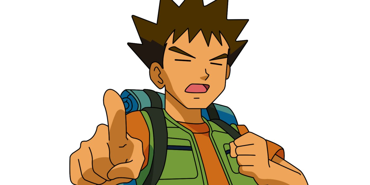 Brock pointing with his right hand while standing in front od a white background