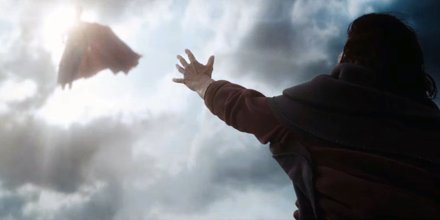 A woman holding her hand up to Superman in the sky in Batman v Superman
