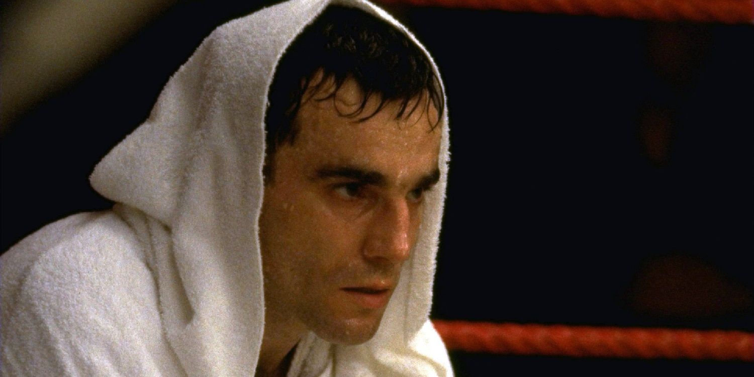 Daniel Day Lewis sits in a boxing ring with a towel on his head in The Boxer