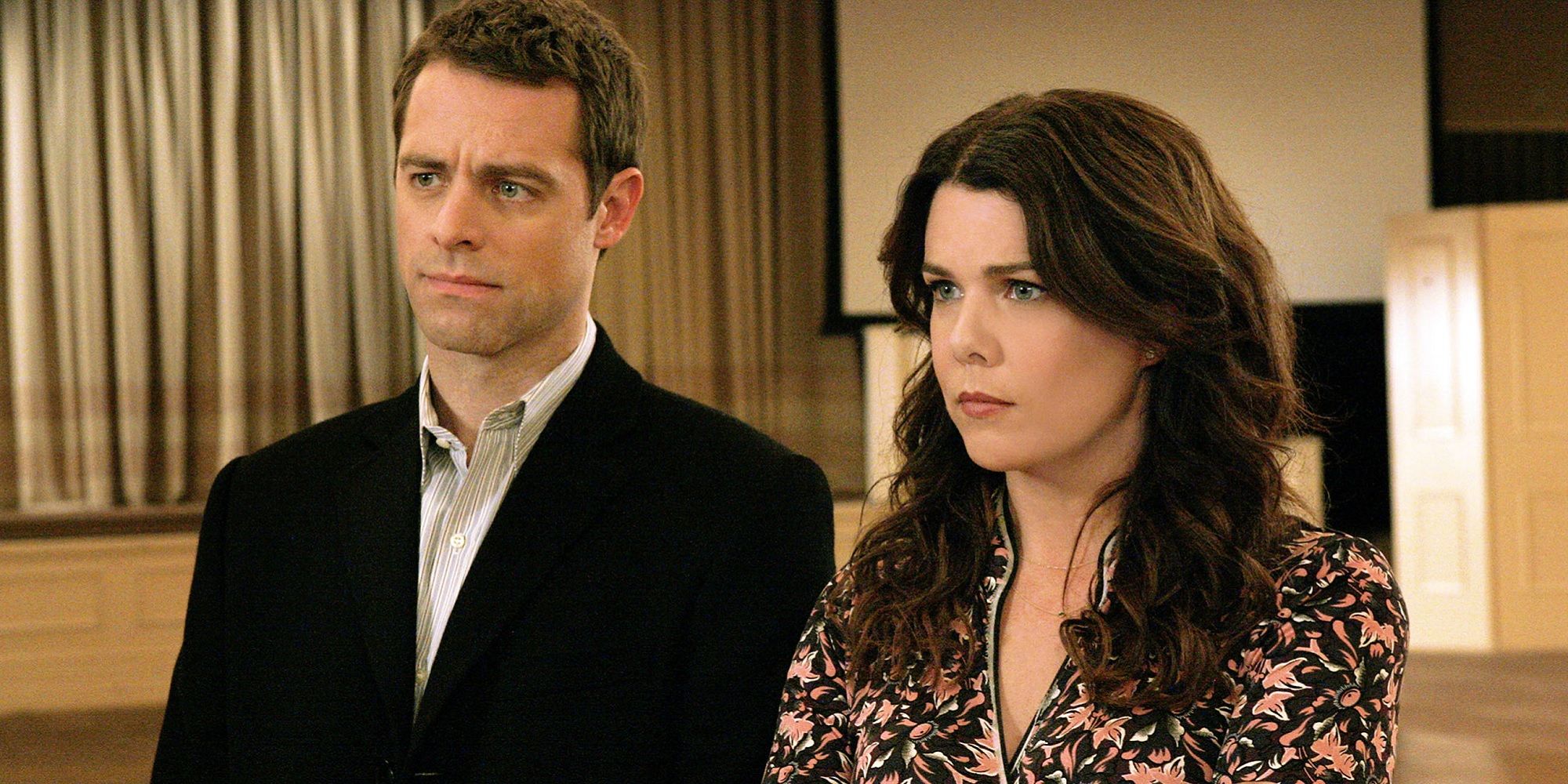 Christopher and Lorelai both look off screen upset in Gilmore Girls