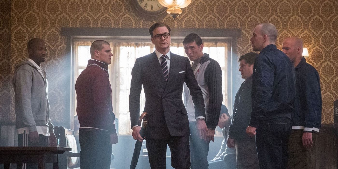 Harry Heart walking into a pub surrounded by people in Kingsman: The Secret Service.