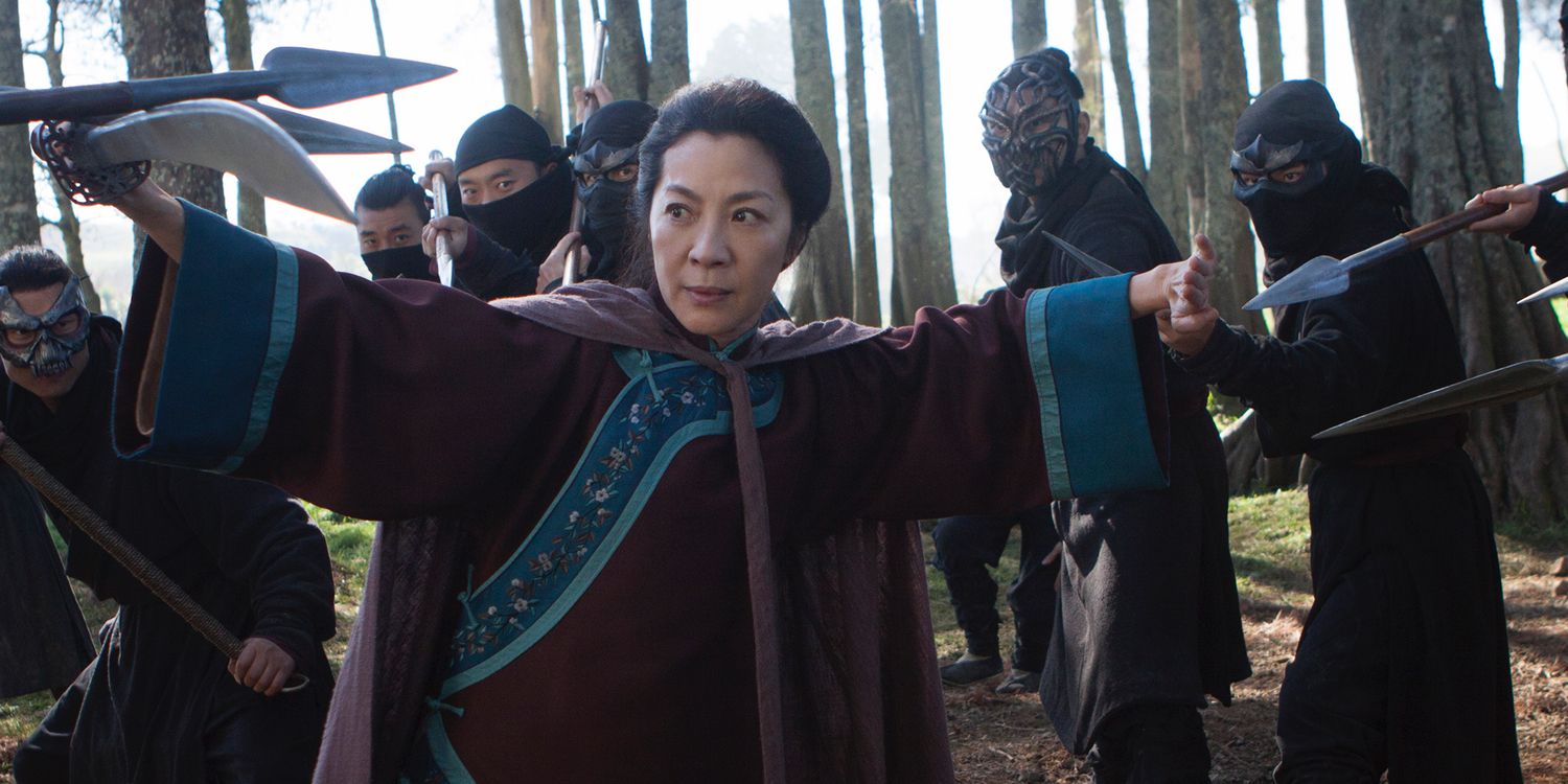 Yu Shu Lien pointing a sword while surrounded by enemies in Crouching Tiger, Hidden Dragon.