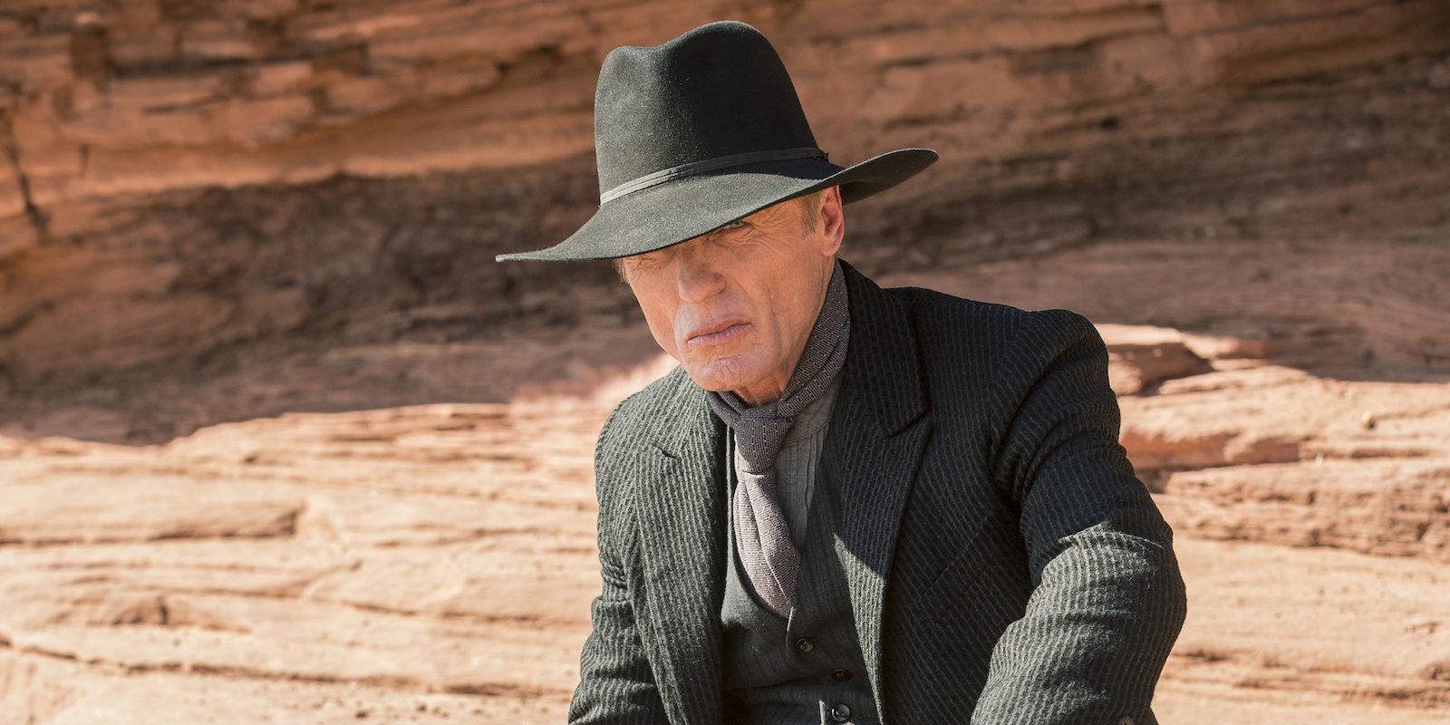  Ed Harris as The Man in Black crouched in a canyon in Westworld