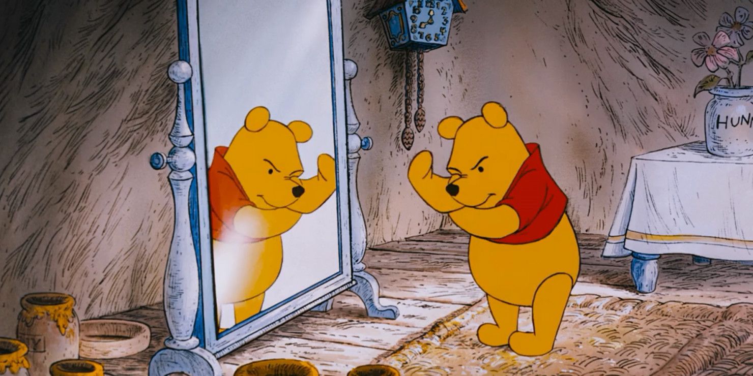 Winnie the Pooh holds his fists up to the mirror in Winnie the Pooh